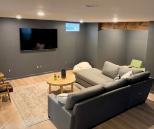 A remodeled basement with furniture.