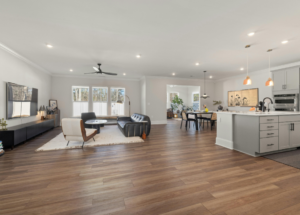 An open concept home featuring a living room, dining room, and kitchen.